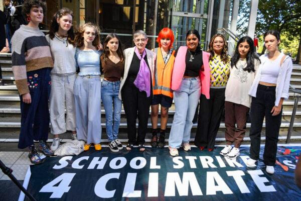 Eight high school students and their 87-year-old litigation representative, Sister Brigid Arthur, stand outside the NSW Federal Court in Sydney, Australia, on March 15, 2022. (AAP Image/Dean Lewins)