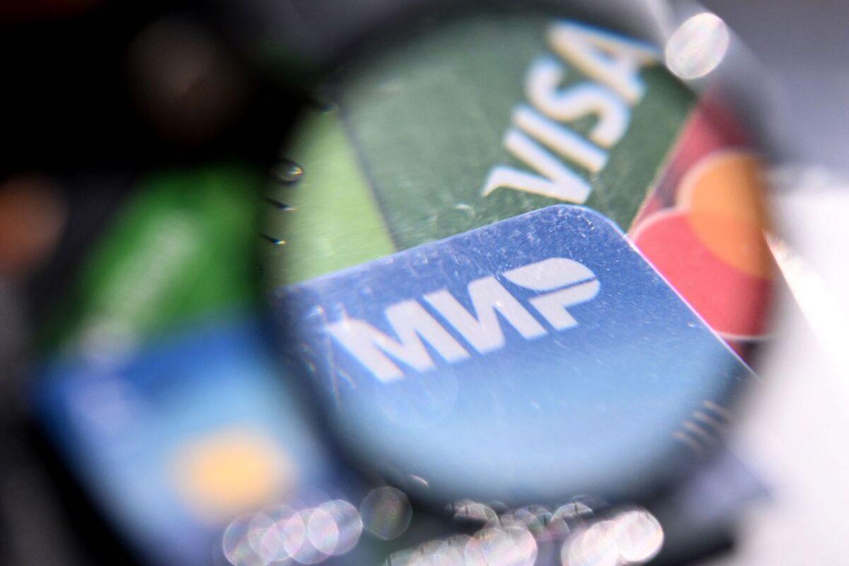 A photo taken on March 14, 2022, shows the logos of Visa, Mastercard, and Russian Mir payment systems on bank cards in Moscow. (AFP via Getty Images)