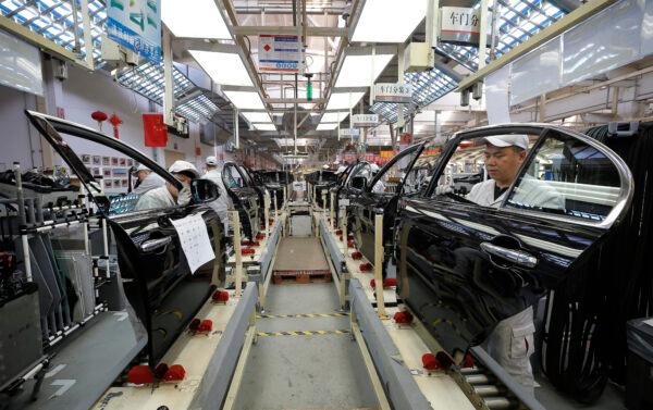 Chinese employees work on a production line of automobiles at a factory in Changchun in China's northeastern Jilin Province, on Nov. 1, 2017. (STR/AFP via Getty Images)