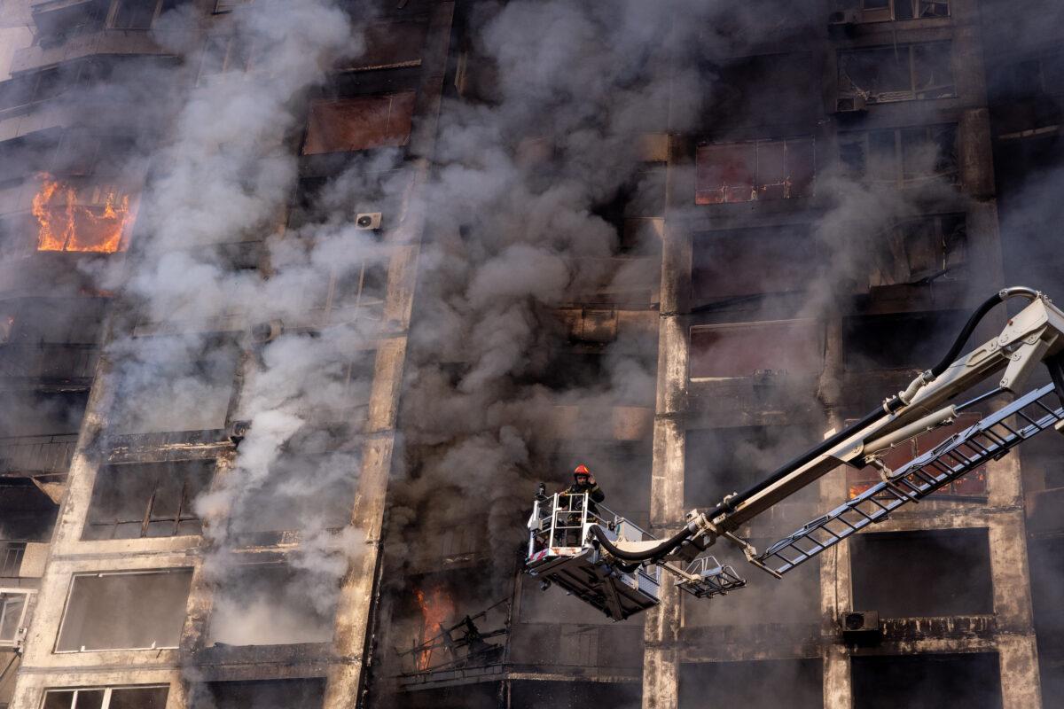 Firefighters work to extinguish a fire at a residential apartment building after it was hit by a Russian attack in the early hours of the morning in the Sviatoshynskyi District in Kyiv, Ukraine, on March 15, 2022. (Chris McGrath/Getty Images)