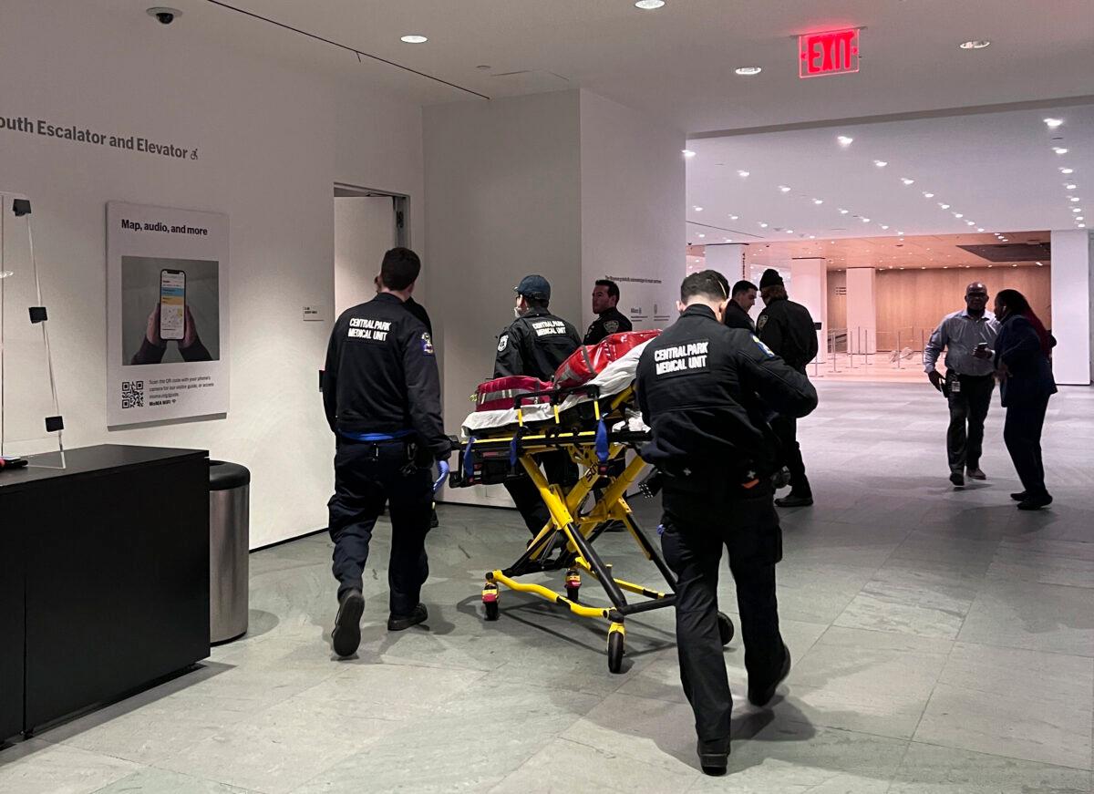 In this photo provided by Yuichi Shimada, medical personnel respond at the Museum of Modern Art in New York after a man stabbed two employees after he was denied entrance for previous incidents of disorderly conduct on March 12, 2022. (Yuichi Shimada via AP)