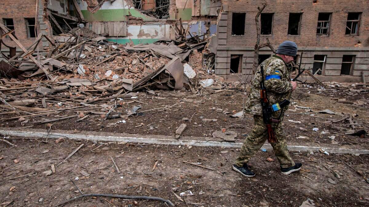 A Ukrainian service member walks past a building destroyed by shelling, as Russia's attack on Ukraine continues, in the town of Okhtyrka, in the Sumy region, Ukraine March 14, 2022. (Iryna Rybakova/Press service of the Ukrainian Ground Forces/Handout via Reuters)