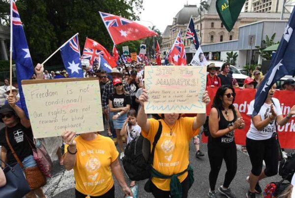 Protesters chanting "My body, my choice," holding signs as they marched through Brisbane's CBD in Brisbane, Tuesday, March 15, 2022. (AAP Image/Darren England).