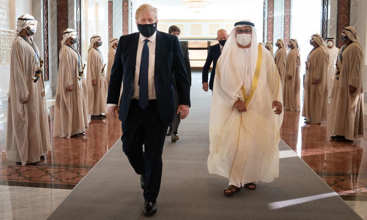 British Prime Minister Boris Johnson inspects the Guard of Honour as he arrives at Abu Dhabi airport for his visit to the United Arab Emirates in Abu Dhabi, United Arab Emirates, on March 16, 2022. (Stefan Rousseau/WPA Pool/Getty Images)