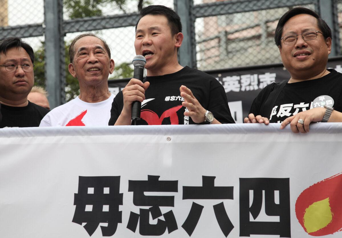 Yan Xiong (2nd R), one of the 21 "most-wanted" Tiananmen Square protesters from 1989, speaks with local pro-democracy leaders before taking part in a demonstration on the streets of Hong Kong on May 31, 2009. (Samantha Sin/AFP via Getty Images)