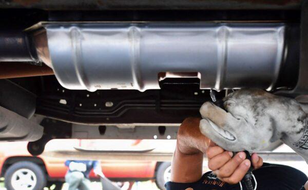 A catalytic converter is engraved with a traceable number. Some police departments are offering this service in response to increased theft of catalytic converters across the U.S. (Frederic J. Brown/AFP via Getty Images)