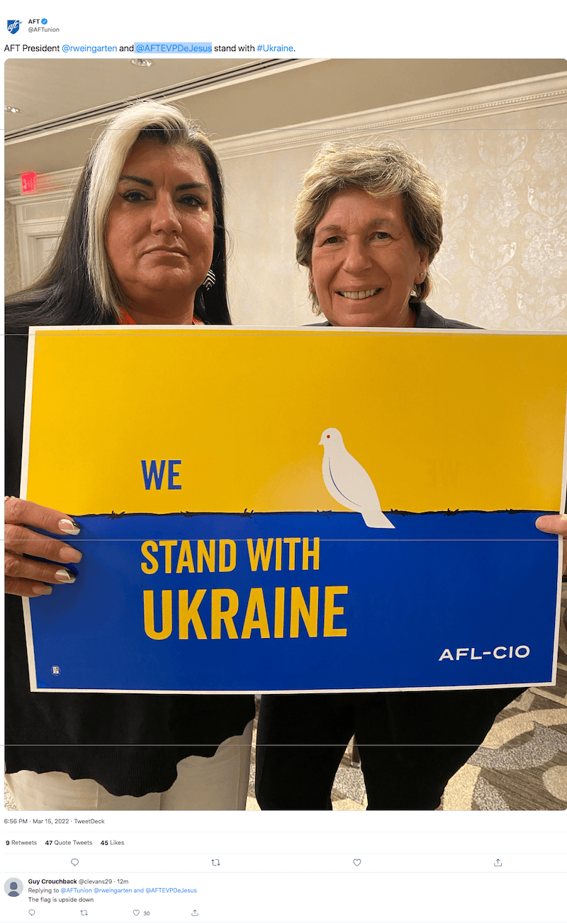 AFT President Randi Weingarten and Executive Vice President Evelyn DeJesus pose with a poster that mistakenly placed Ukraine's national colors in reverse. (Twitter)