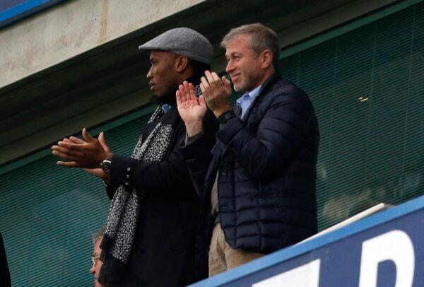 Former Chelsea FC forward Didier Drogba (L) and Chelsea's Russian owner Roman Abramovich celebrate after Chelsea scored during an English Premier League football match between Chelsea and Sunderland at Stamford Bridge, in London, Dec. 19, 2015. (Ian Kington/Getty Images)