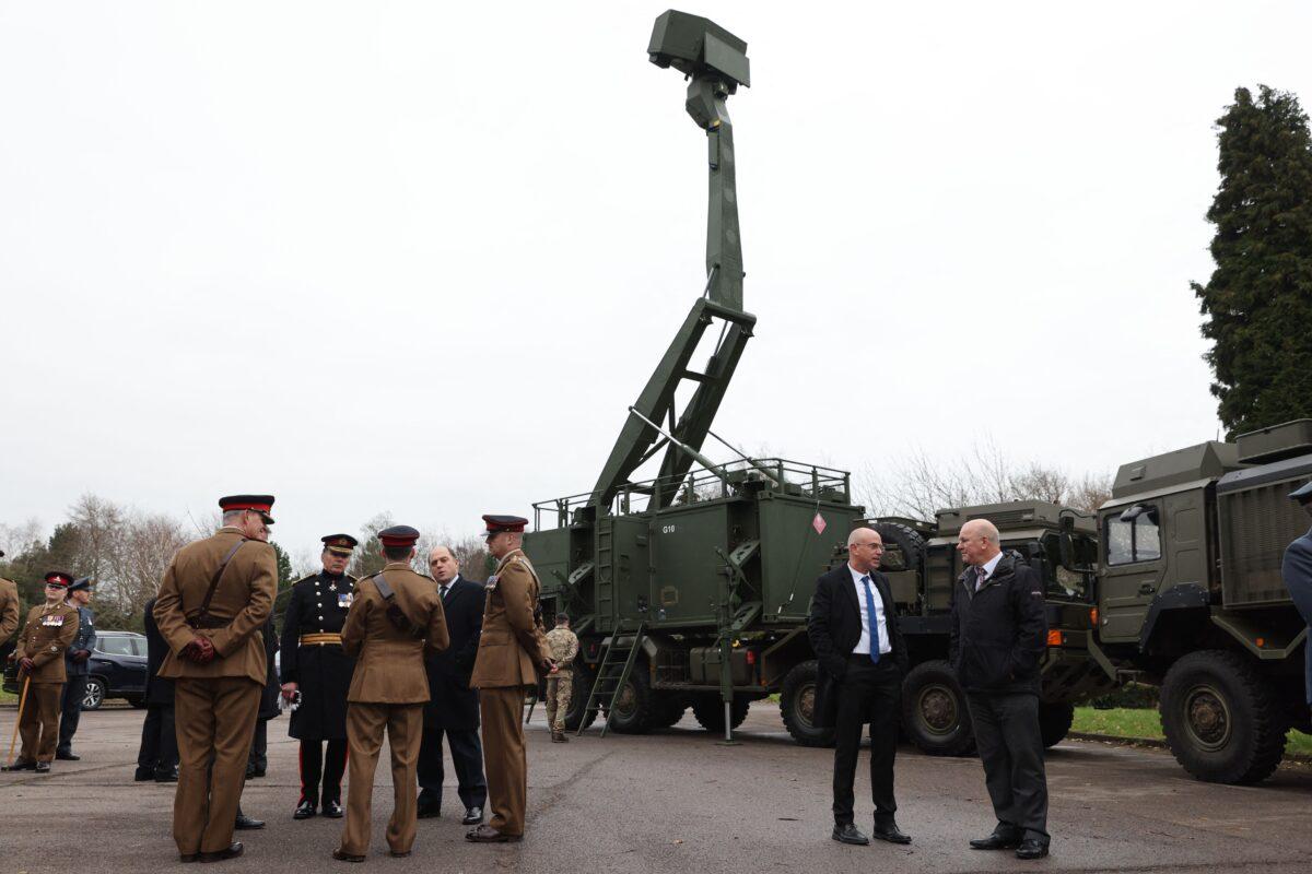 Britain's Defence Secretary Ben Wallace (centre left) speaks with officers in front of the Saab Giraffe surveillance radar (C), a key component of the Sky Sabre air defence system at the Royal Artillery's change of colours parade at Baker Barracks, Thorney Island, southern England, on Jan. 27, 2022. (Adrian Dennis/AFP via Getty Images)