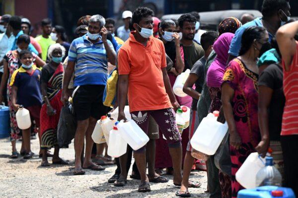 People stand in a queue to buy kerosene oil for home use at a petrol station in Colombo, Sri Lanka on March 17, 2022. (Ishara S. Kodikara/AFP via Getty Images)