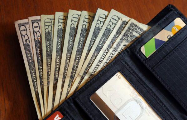 Cash is fanned out from a wallet in North Andover, Mass. on June 15, 2018. (Elise Amendola/AP Photo)
