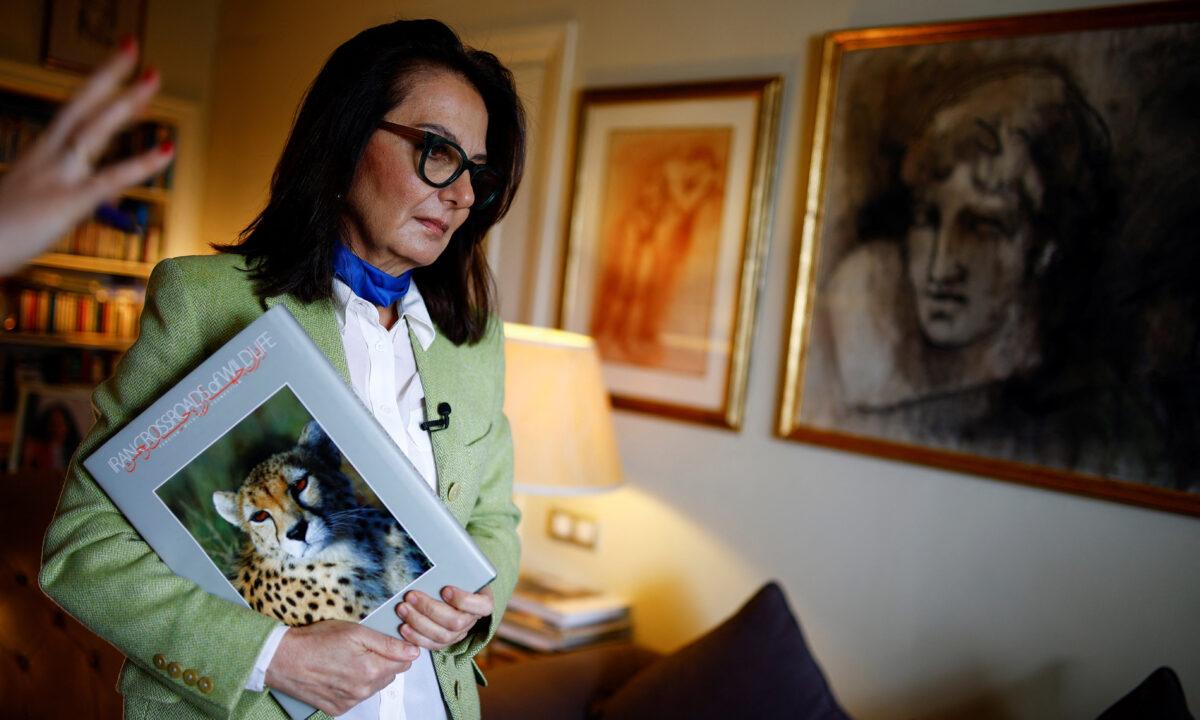 Tahrane Tahbaz, sister of detained Iranian–American environmentalist Morad Tahbaz, who also holds British citizenship, holds a book that her brother made, after talking with Reuters at her home in Madrid, Spain, on March 18, 2022. (Juan Medina/Reuters)