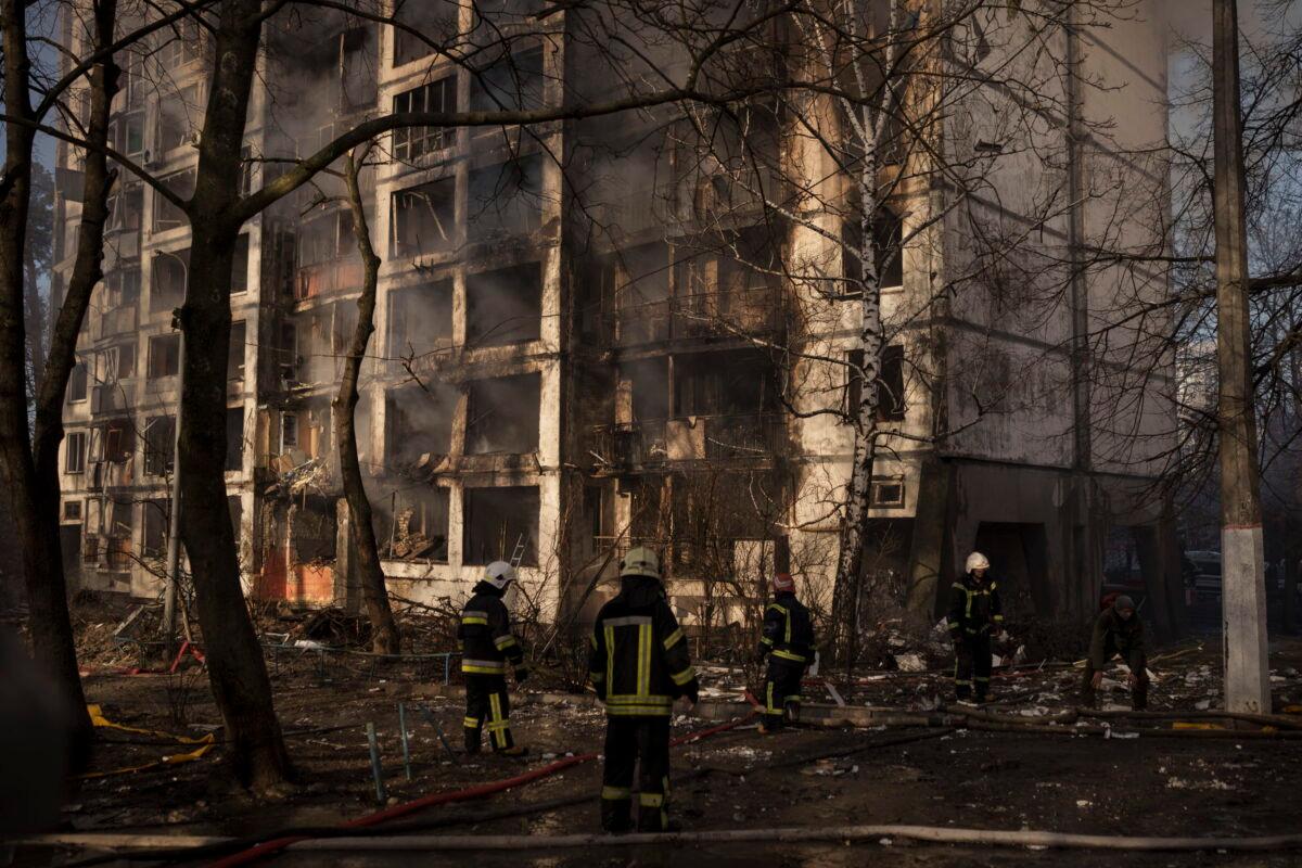 Firefighters work at the scene of an apartment building bombing in Kyiv, Ukraine, on March 15, 2022. (Felipe Dana/AP Photo)