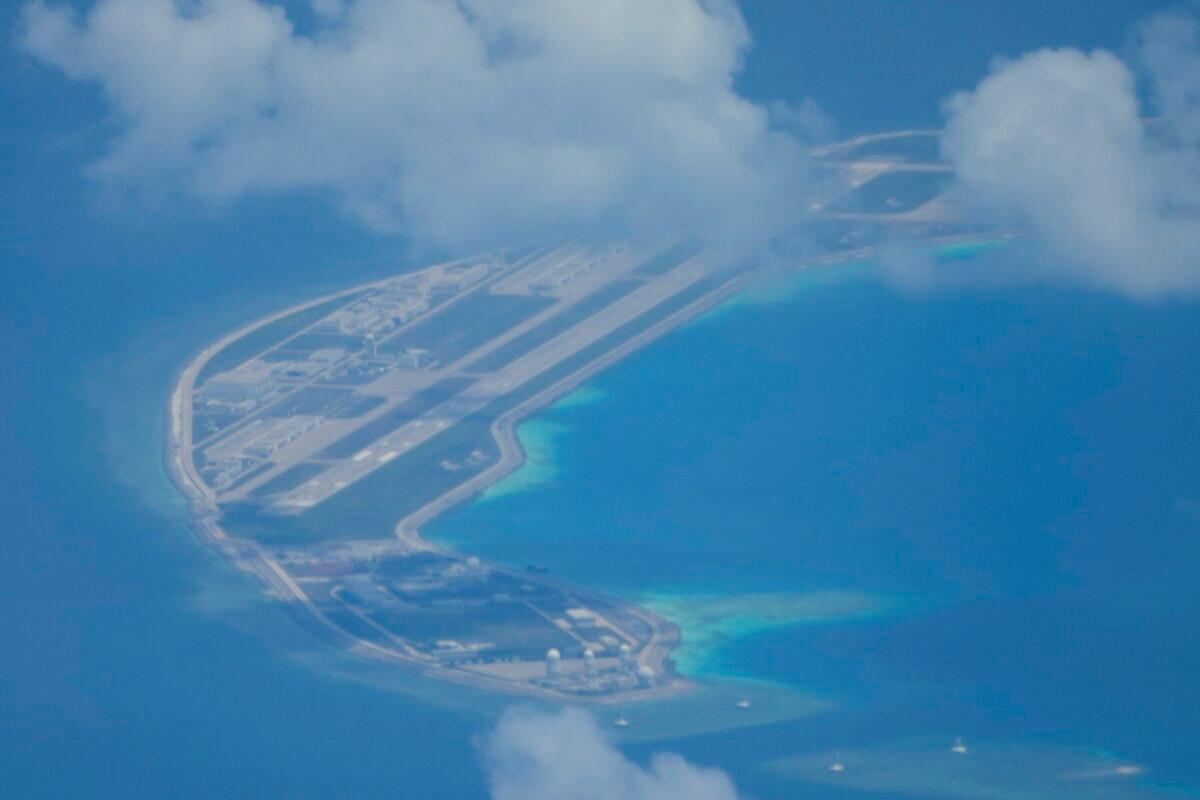 An airstrip made by China is visible beside structures and buildings on the man-made island in the Spratlys group of islands in the South China Sea on March 20, 2022. (Aaron Favila/AP Photo)