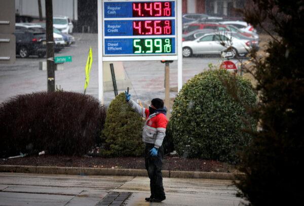 A worker takes pictures of gasoline prices at a gas station, following Russia's invasion of Ukraine, in Jersey City, New Jersey, on March 9, 2022. (Mike Segar/Reuters)