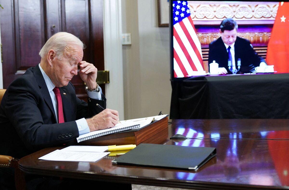U.S. President Joe Biden gestures as he meets with Chinese leader Xi Jinping during a virtual summit from the Roosevelt Room of the White House in Washington, on Nov. 15, 2021. (Mandel Ngan/AFP via Getty Images)
