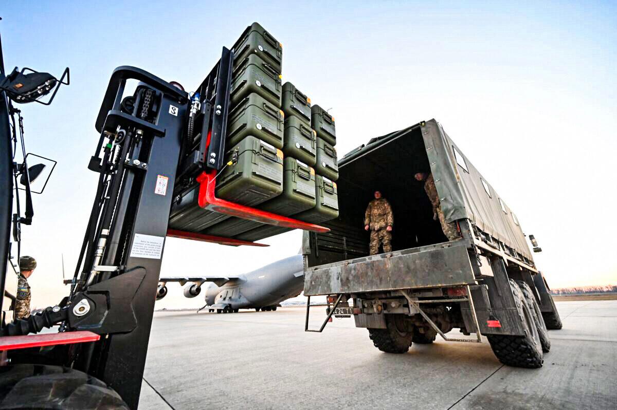 Servicemen of Ukrainian Military Forces move U.S.-made FIM-92 Stinger missiles and the other military assistance shipped from Lithuania to Boryspil Airport in Kyiv, Ukraine, on Feb. 13, 2022. (Sergei Supinsky/AFP via Getty Images)