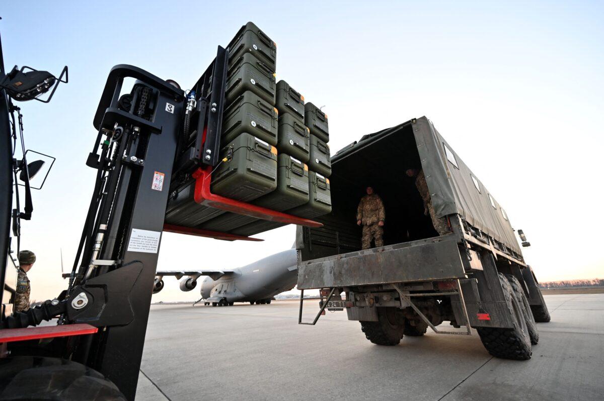 Servicemen of Ukrainian Military Forces move U.S.-made FIM-92 Stinger missiles and other military assistance shipped from Lithuania to Boryspil Airport in Kyiv on Feb. 13, 2022. (Sergei Supinsky/AFP via Getty Images)