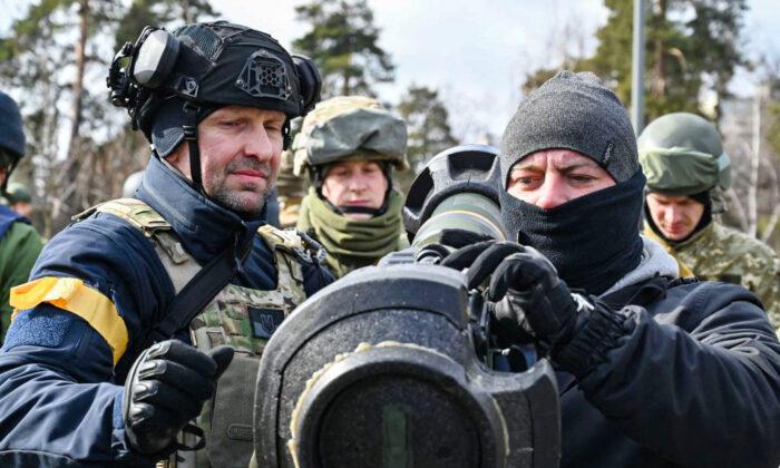 Members of the Ukrainian Territorial Defense Forces examine new armament, including NLAW anti-tank systems and other portable anti-tank grenade launchers, in Kyiv, Ukraine, on March 9, 2022. (Genya Savilov/AFP via Getty Images)