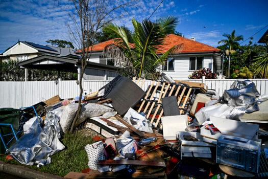 Flood-damaged items and debris are left outside a house in Brisbane, Australia, on March 6, 2022. (Dan Peled/Getty Images)