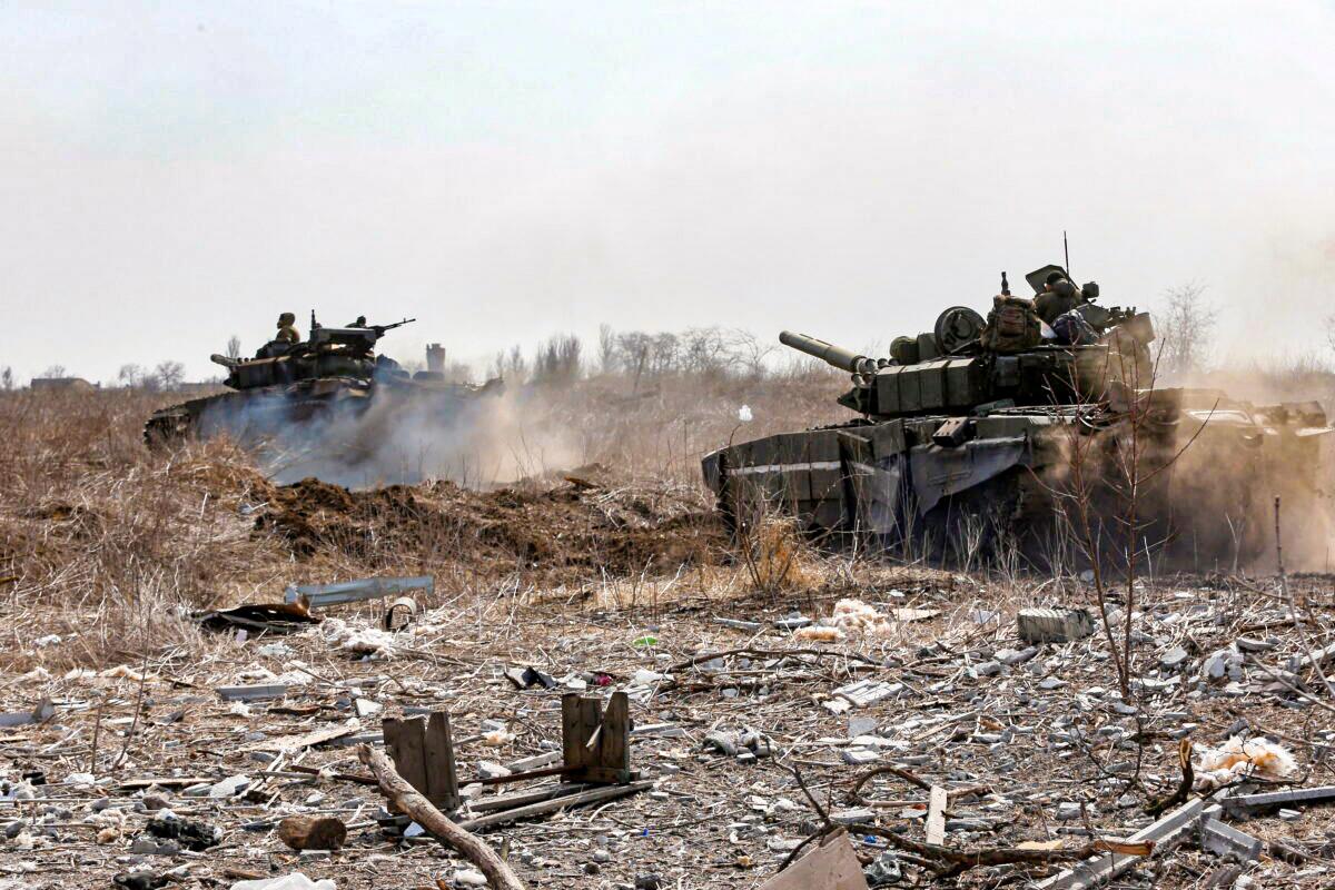 Service members of pro-Russian troops are seen atop tanks during the Ukraine-Russia conflict on the outskirts of the besieged southern port city of Mariupol, Ukraine, on March 20, 2022. (Alexander Ermochenko/Reuters)