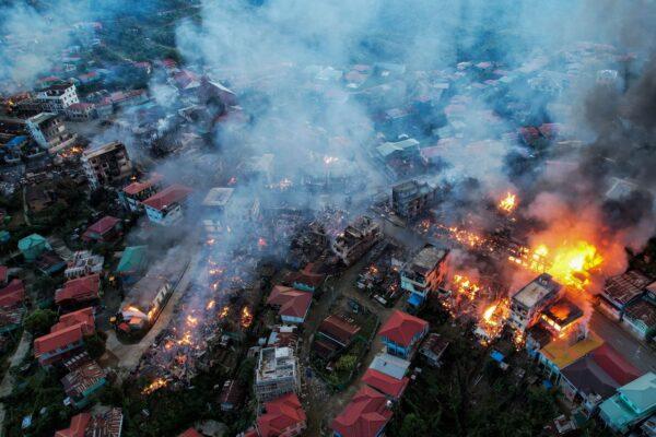 This aerial photo taken on Oct. 29, 2021, shows smokes and fires from Thantlang, in Chin State, where more than 160 buildings were destroyed by shelling from Junta military troops, according to local media. (STR/AFP via Getty Images)