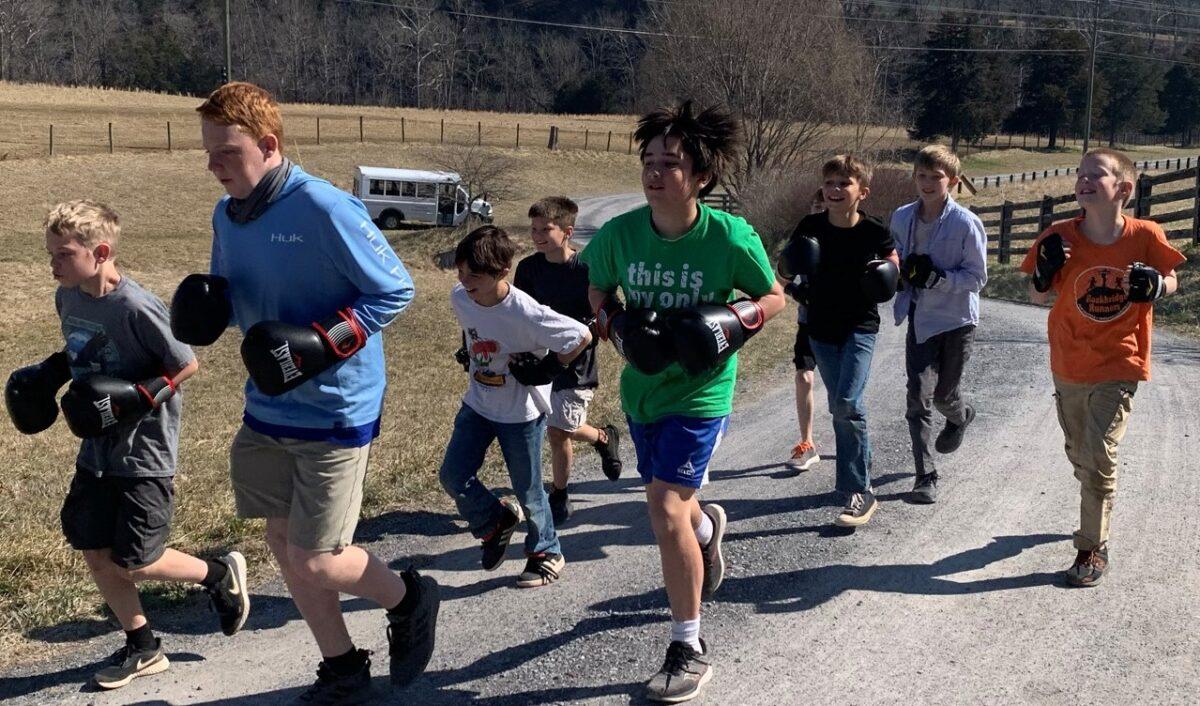 Students run prior to boxing lessons. For two years in a row, the former boxing coach for Virginia Military Institute, Lance Thomson, has spent a week teaching self-defense and boxing. (Courtesy of BCBS)