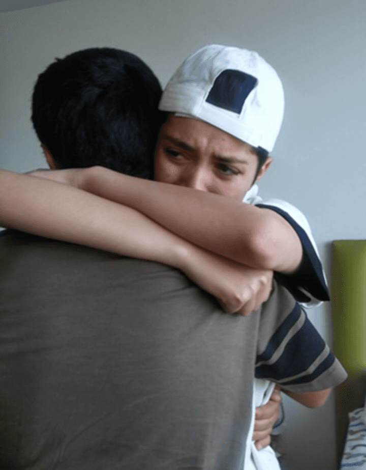  Yaeli Martinez (R) hugs her younger brother on her 17th birthday at the group home in Los Angeles when Martinez surprised her and brought Yaeli's brother and sisters to visit. (Courtesy of Abigail Martinez)