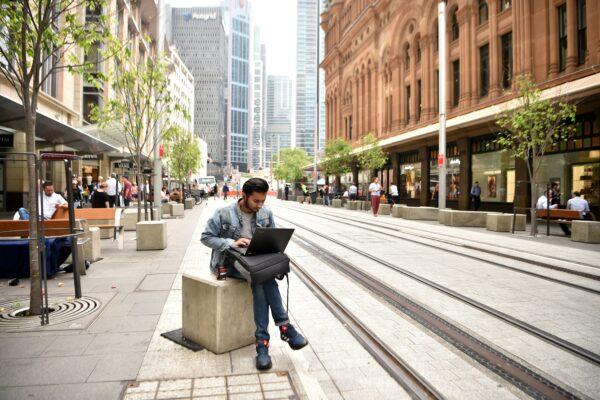 This photo shows a man using a laptop computer on the street in the central business district of Sydney, in Australia, on Nov. 5, 2018. (Peter Parks/AFP via Getty Images)