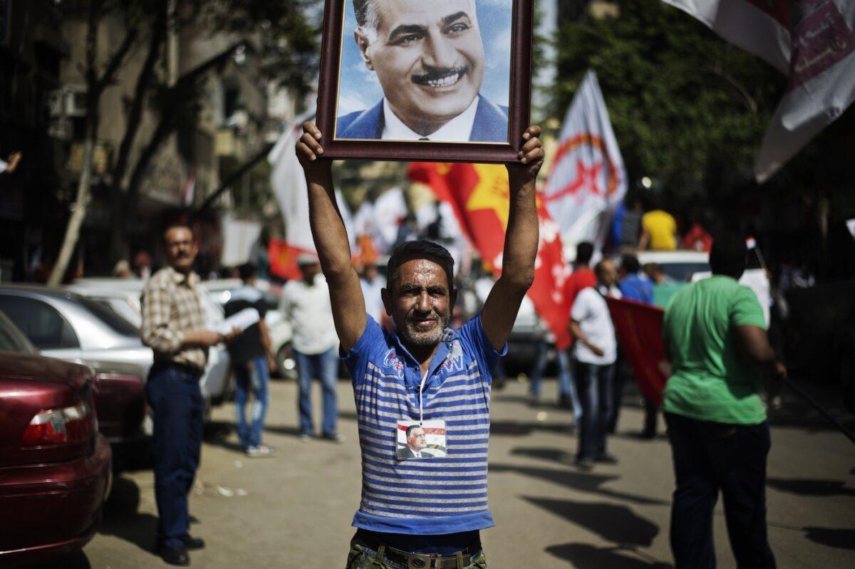An Egyptian man holds a portrait of former Egyptian leader Gamal Abdel Nasser during a demonstration of members of the Egyptian Communist Party in Cairo, Egypt on May 1, 2013. (Gianluigi Guercia/AFP via Getty Images)