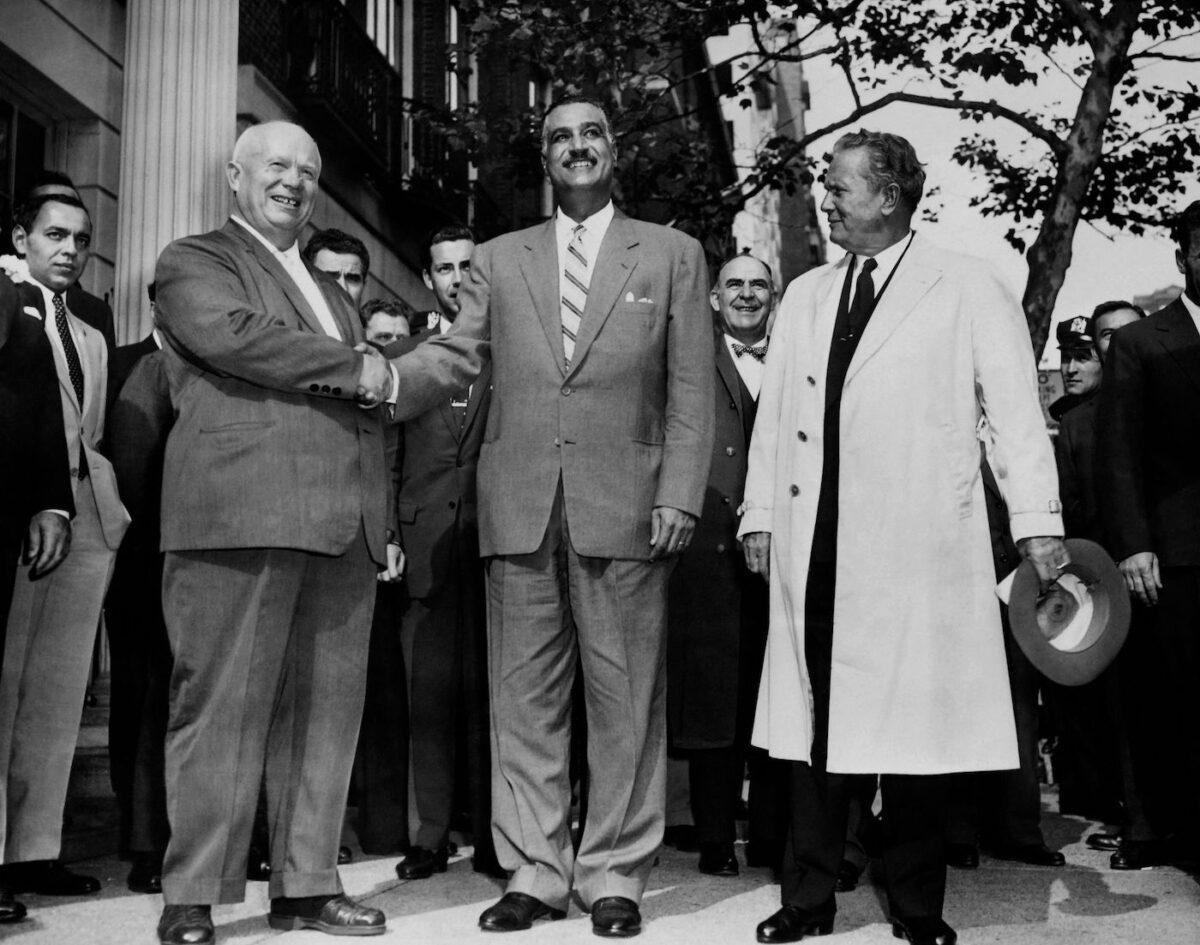 General Secretary of the Central Committee of the Communist Party of the Soviet Union Nikita Khrushchev (L) shakes hands with President of Egypt Gamal Abdel Nasser (C) as President of Yugoslavia Josip Broz Tito (R) looks on at the United Nations, New York in September 1960. (AFP via Getty Images)
