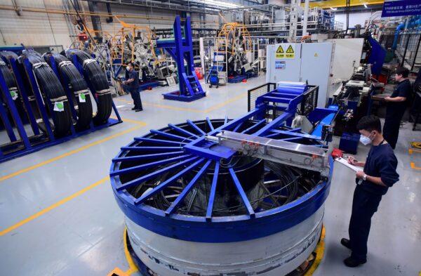 Employees are working on a production line of automobiles at the BMW factory in Shenyang in China's northeastern Liaoning Province on Nov. 22, 2017. (AFP via Getty Images)