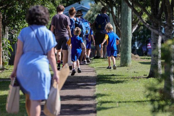 Students are seen entering school grounds for their first day back of the year in Brisbane, Australia, on Feb, 7, 2022. (AAP Image/Russell Freeman)