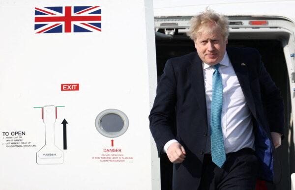 Britain's Prime Minister Boris Johnson disembarks from an aircraft ahead of an extraordinary summit at NATO Headquarters in Brussels, on March 24, 2022. (Henry Nicholls /Pool/AFP via Getty Images)