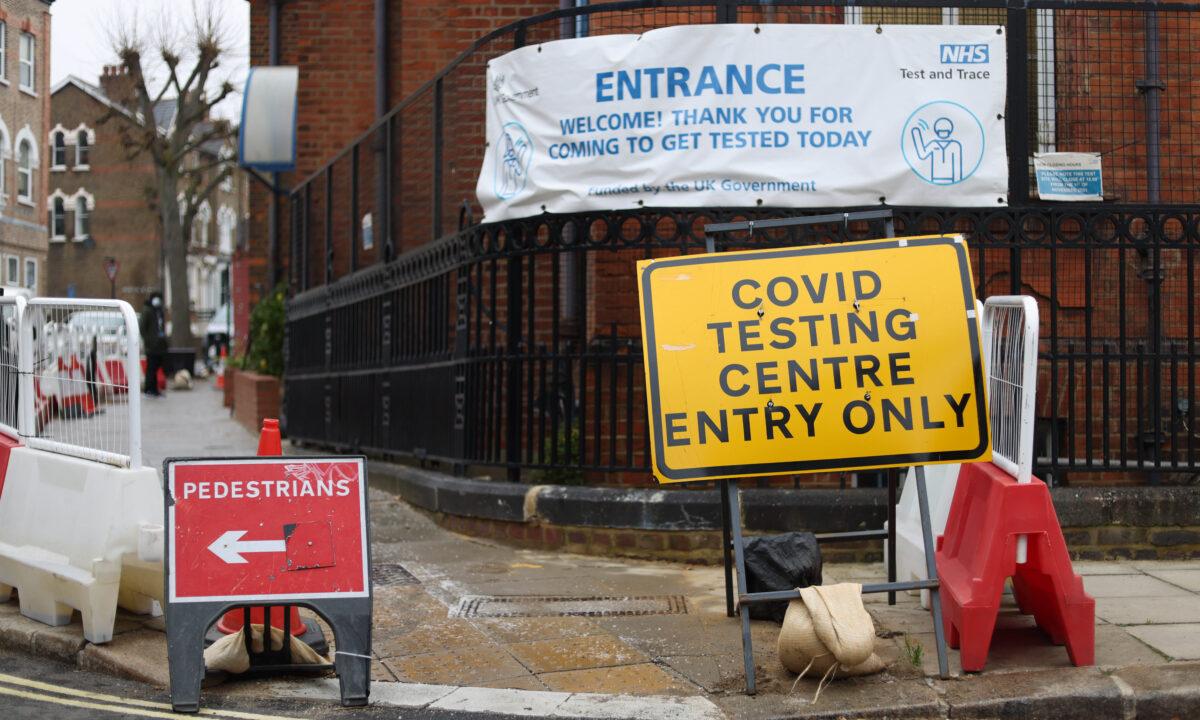 Signs outside a COVID-19 testing centre in Camden, London, on Dec. 23, 2021. (Hollie Adams/Getty Images)