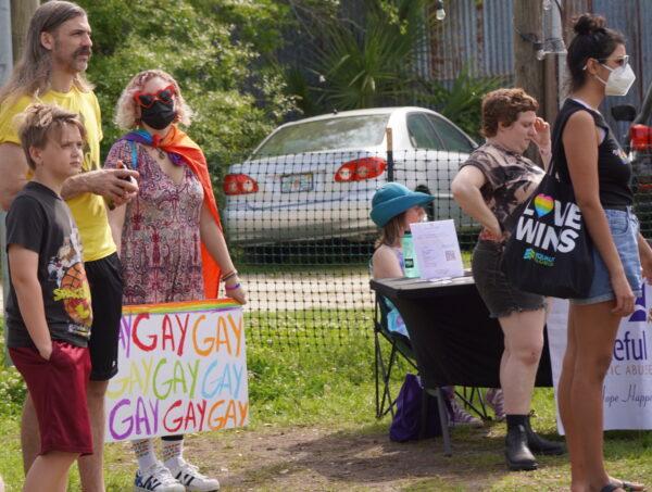 Attendees at the "We Say Gay-nesville" rally in Gainesville, Fla., listen on March 19, 2022, to speakers opposed to the Parental Rights in Education bill, recently approved by the Florida Legislature, and signed into law by the state's governor. (Natasha Holt/The Epoch Times)