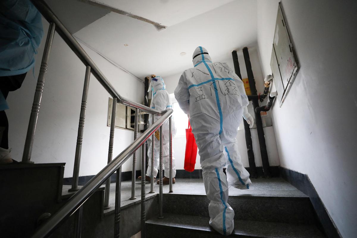 Medical workers prepare to conduct nucleic acid tests for the Covid-19 coronavirus on residents who can't leave their premises conveniently in Shenyang in China's northeastern Liaoning province on March 23, 2022. (STR/AFP via Getty Images)