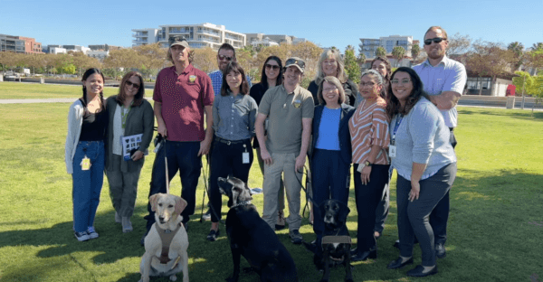 Podder (R) the agricultural detector dog is retired from San Diego County's Agriculture, Weights and Measures Department on March 23, 2022. (Screenshot via YouTube/countysandiego)