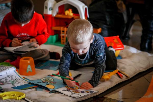 Svetlana Isakova's son plays in a room for mothers and small children at the Lviv train station, in Lviv, Ukraine, on March 24, 2022. (Charlotte Cuthbertson/The Epoch Times)