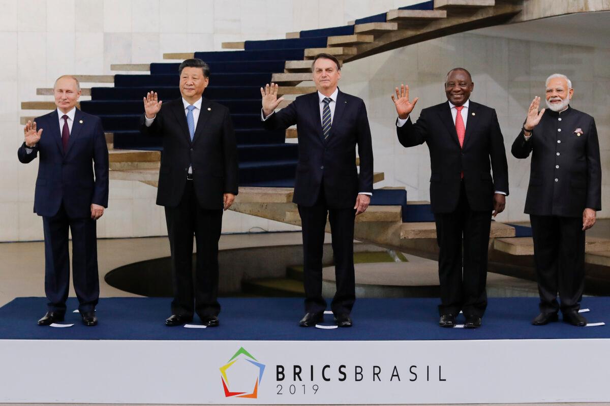 (From left) Russian President Vladimir Putin, Chinese leader Xi Jinping, then-Brazilian President Jair Bolsonaro, South African President Cyril Ramaphosa, and Indian Prime Minister Narendra Modi pose for a family picture during the 11th BRICS Summit in Brasilia, Brazil, on Nov. 14, 2019. (Sergio Lima/AFP via Getty Images)