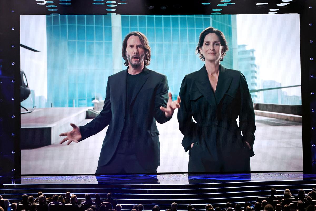 Keanu Reeves and Carrie-Anne Moss speak onscreen during The Game Awards 2021 at Microsoft Theater in Los Angeles, on Dec. 09, 2021. (Kevin Winter/Getty Images)