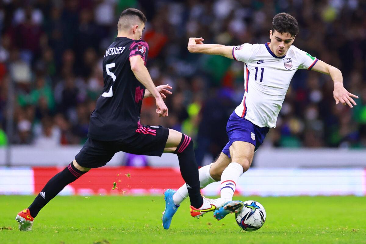 Giovanni Reyna of United States fights for the ball with Johan Vásquez of Mexico during a match between Mexico and United States as part of CONCACAF 2022 FIFA World Cup Qualifiers at Azteca Stadium, in Mexico City, on March 24, 2022. (Hector Vivas/Getty Images)