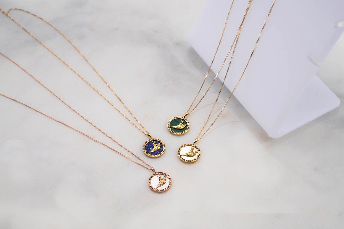 The Divine Grace Fine Jewelry Pendants, in 18k yellow and rose gold, set with lapis, malachite, white mother of pearl, and gold mother of pearl. (Courtesy of Shen Yun Shop)