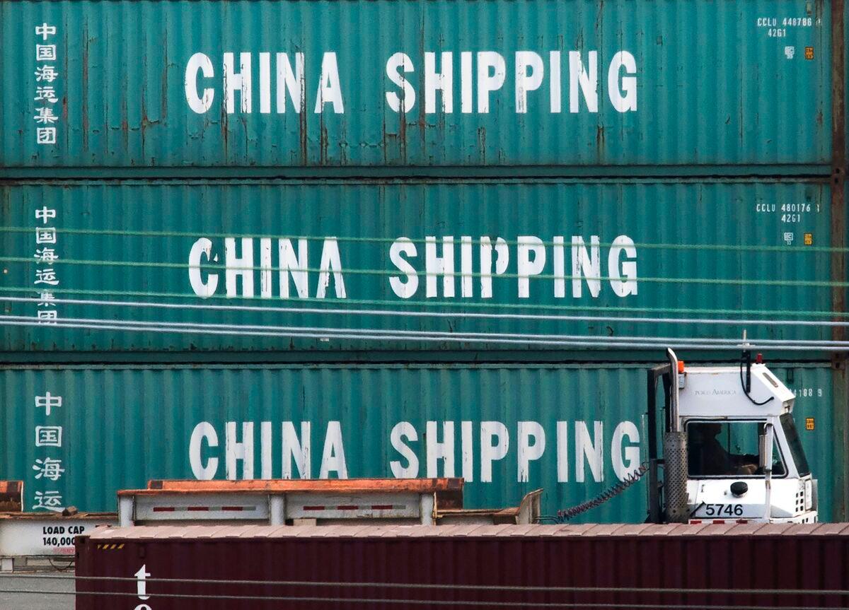 A truck passes by China Shipping containers at the Port of Los Angeles in Long Beach, Calif., on Sept. 1, 2019. (Mark Ralston/AFP via Getty Images)