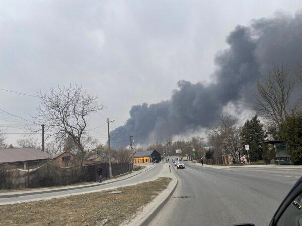 Black smoke billows after authorities said a missile attack hit an industrial area of Lviv, Ukraine, on March 26, 2022. (Charlotte Cuthbertson/The Epoch Times)