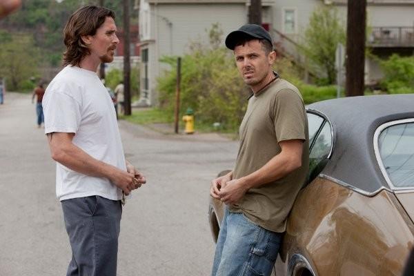 Steelworker Russell Baze (Christian Baze, L) and his ex-military younger brother Rodney (Casey Affleck) in "Out of the Furnace." (Relativity Media)