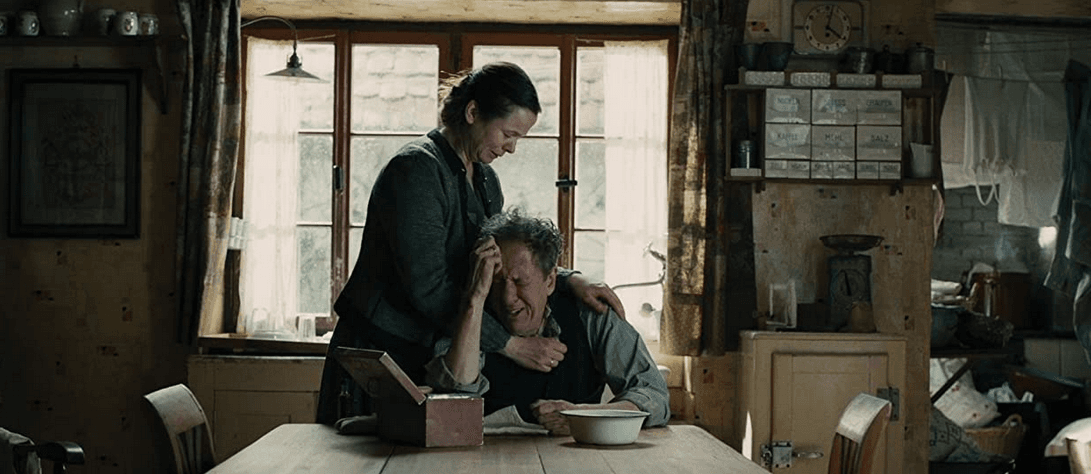 Rosa Hubermann (Emily Watson) comforts her grief-stricken husband, Hans (Geoffrey Rush), in "The Book Thief." (20th Century Fox)