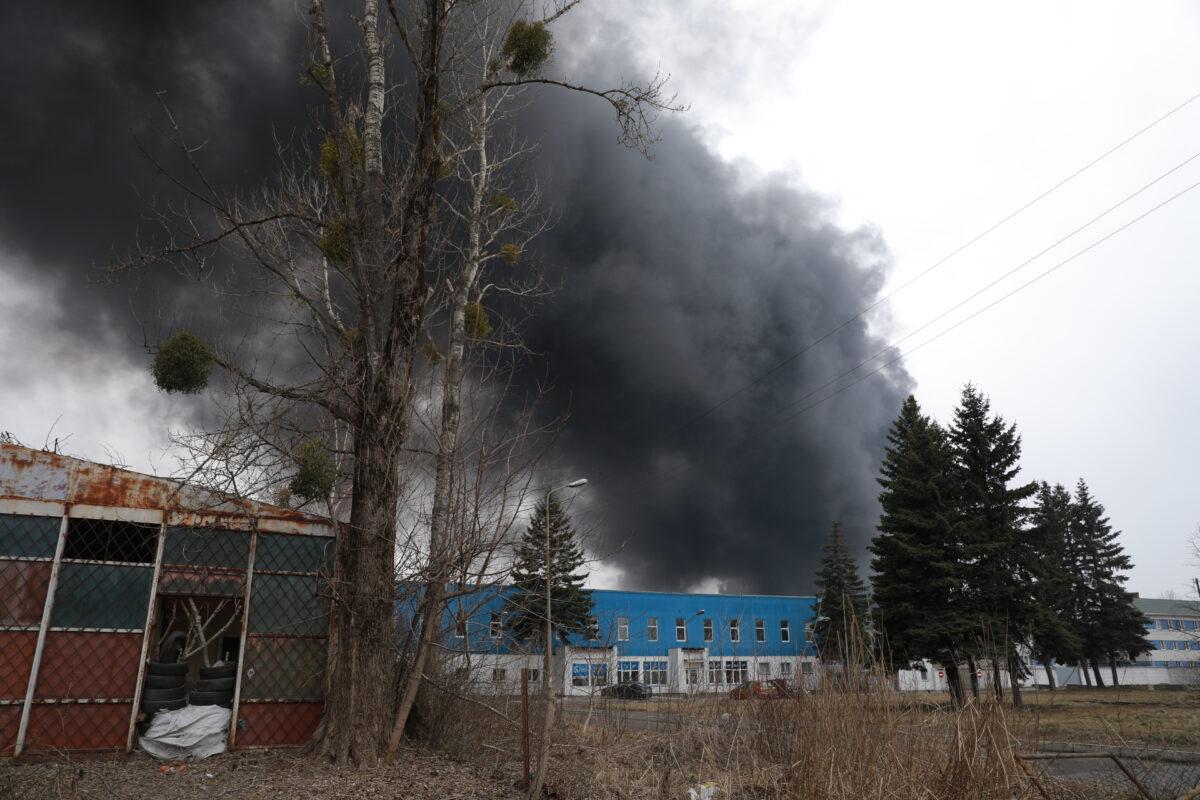 Black smoke billows after authorities said a missile attack hit an industrial area of Lviv, Ukraine, on March 26, 2022. (Charlotte Cuthbertson/The Epoch Times)