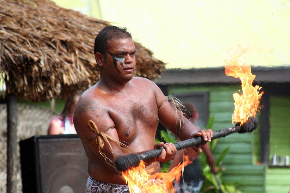 A Fijian performs a traditional fire dance. (Rachelle Burnside/ Shutterstock)