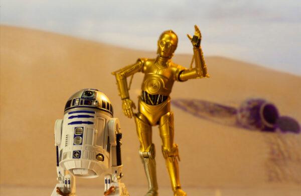 A recreation of a scene from “Star Wars” showing the comic robots R2D2 (L) and C-3PO on the desert planet of Tatooine with escape pod. (Willrow Hood/Shutterstock)